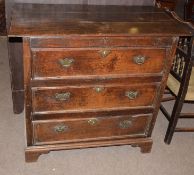 18th century country oak chest of three drawers with brass fittings, panelled sides and bracket