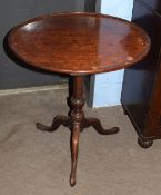 19th century mahogany pedestal wine table, the circular snap top with raised edge (repairs) on a