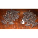 Interesting pair of carved and pierced stained softwood wall hangings in classical style featuring a