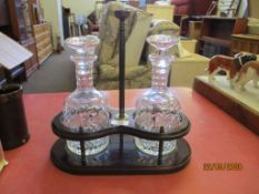 EARLY 20TH CENTURY TANTALUS COMPLETE WITH A PAIR OF CUT GLASS DECANTERS, TOTAL HEIGHT APPROX 31CM