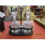 EARLY 20TH CENTURY TANTALUS COMPLETE WITH A PAIR OF CUT GLASS DECANTERS, TOTAL HEIGHT APPROX 31CM