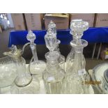 FIVE VARIOUS DECANTERS TOGETHER WITH A SILVER PLATE MOUNTED CLARET JUG, LARGEST APPROX 34CM INC