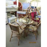 GLASS TOPPED CANE CIRCULAR CONSERVATORY DINING TABLE, TOGETHER WITH FOUR MATCHING CARVER CHAIRS, THE