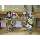 FOUR CONTINENTAL PORCELAIN FIGURINES OF STREET SELLERS ON TYPICAL GILT SCROLL BASES