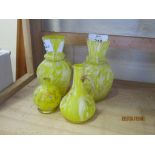 GROUP OF COLOURED YELLOW GLASS WITH GILT DECORATION INCLUDING TWO VASES, TWO SMALL EWERS