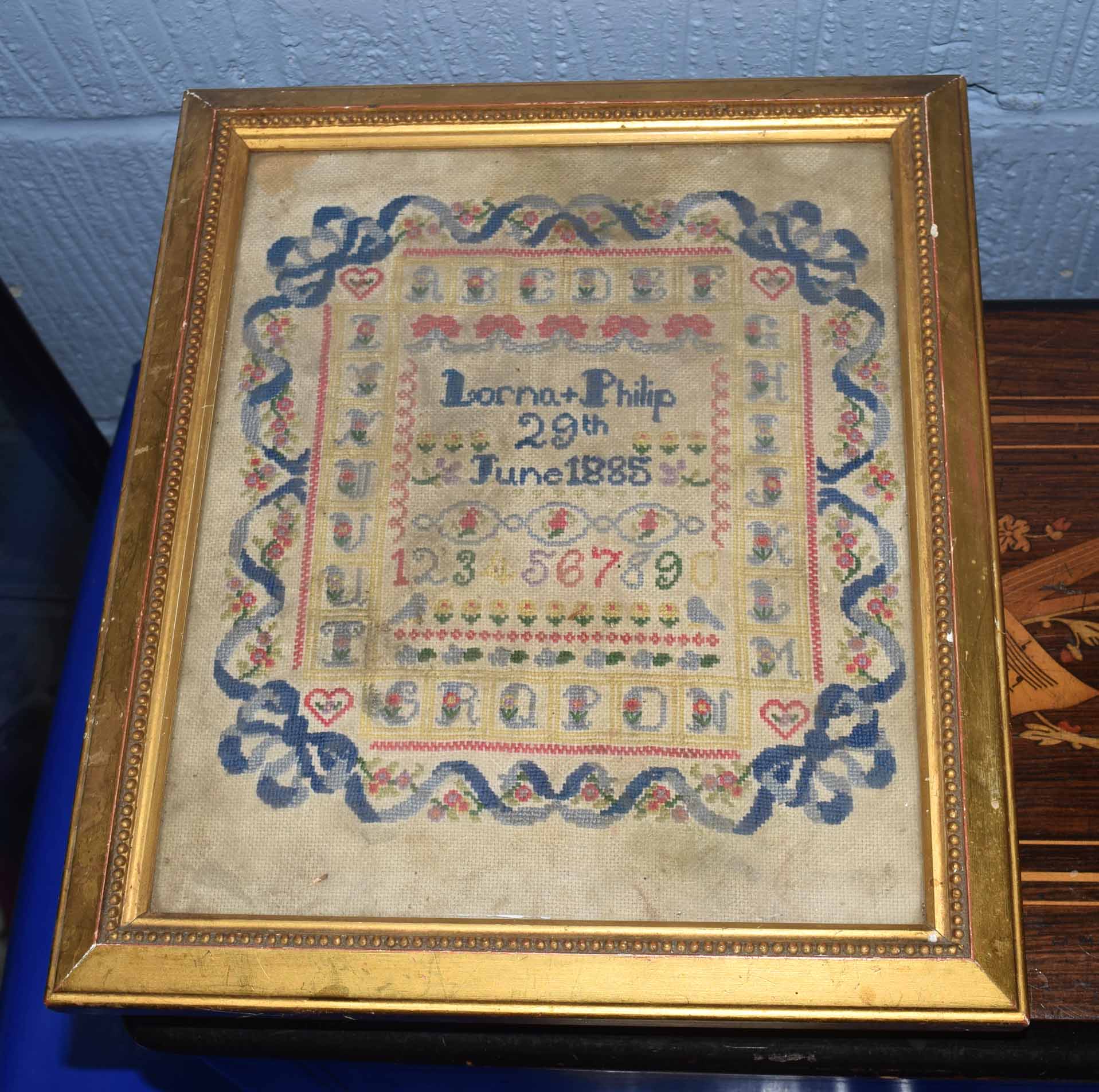 Victorian sampler, wool stitched on gauze, square frame with capital letters, the centre