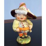 Late 18th century Derby model of a mansion house dwarf, his hat inscribed "Farming Implements by