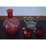 Group of four glass wares including a globular ruby decanter, two small cups and a further green