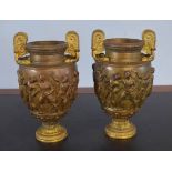 Pair of parcel gilded bronze patinated two-handled vases, bodies each embossed with classical