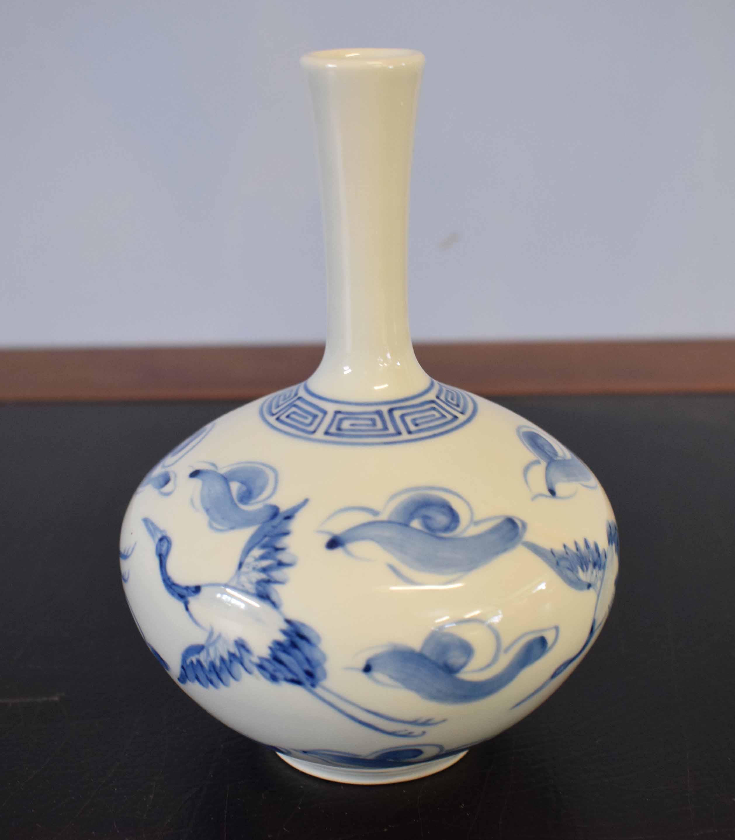 Japanese porcelain vase with blue and white design of herons amongst clouds, 15cm high