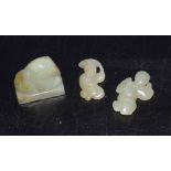 Group of three green jade pieces including a seal with a mythical beast carving, and two small