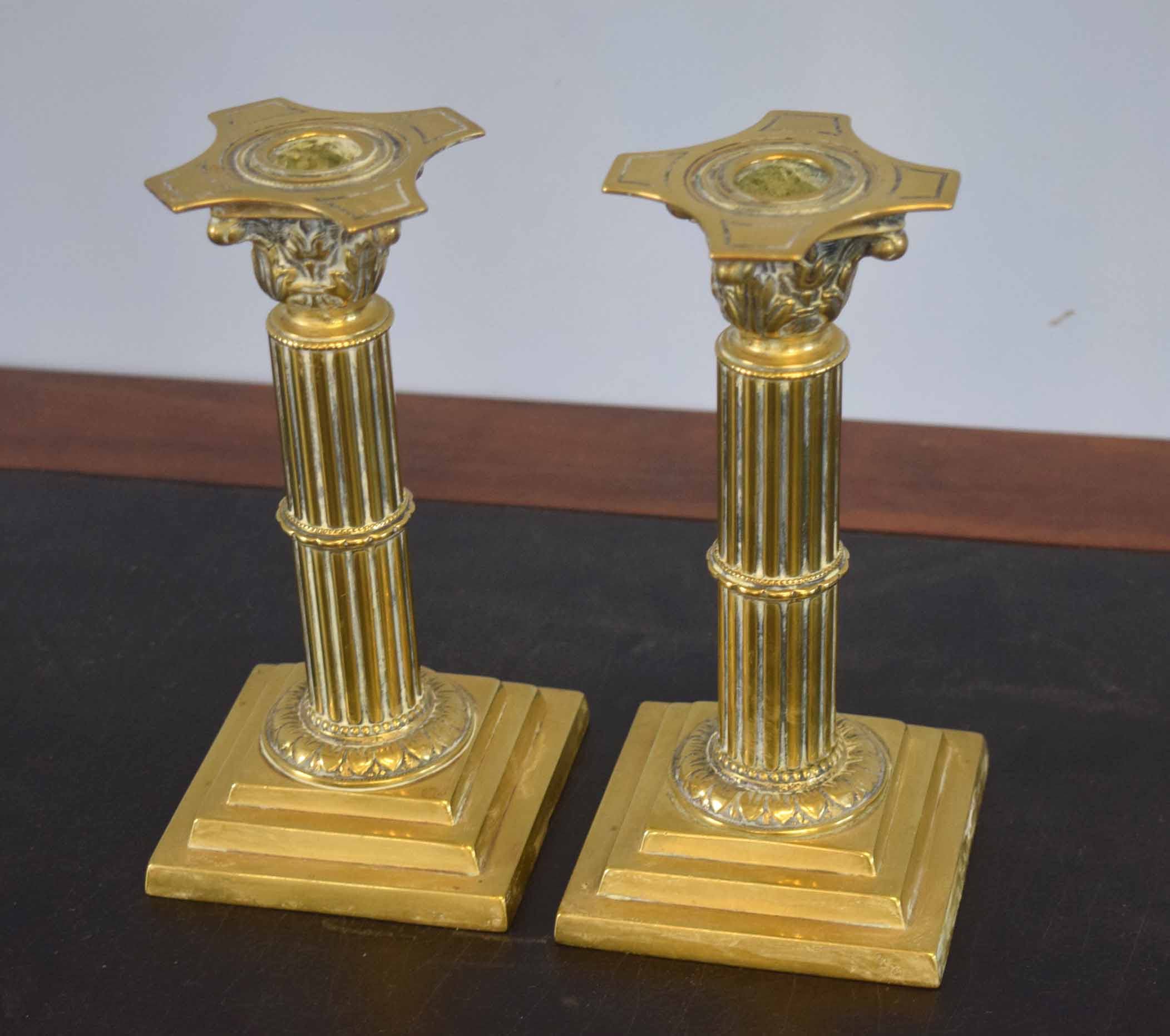 Pair of late 19th/early 20th century brass candlesticks with Corinthian column stems and stepped