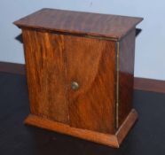 Early 20th century oak key cabinet, of rectangular form with moulded edge over two doors enclosing