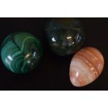 Box containing three large marbles