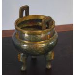 Chinese bronze censer of archaic form on three stump feet, the green ground with gilt decoration