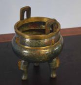 Chinese bronze censer of archaic form on three stump feet, the green ground with gilt decoration