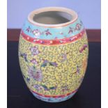 Chinese porcelain barrel shaped jar, (cover lacking), with a scroll design on yellow ground, 16cm