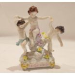 Continental group of three dancing putti on rock work raised on four stub legs