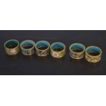 Collection of six champleve enamel decorated napkin rings