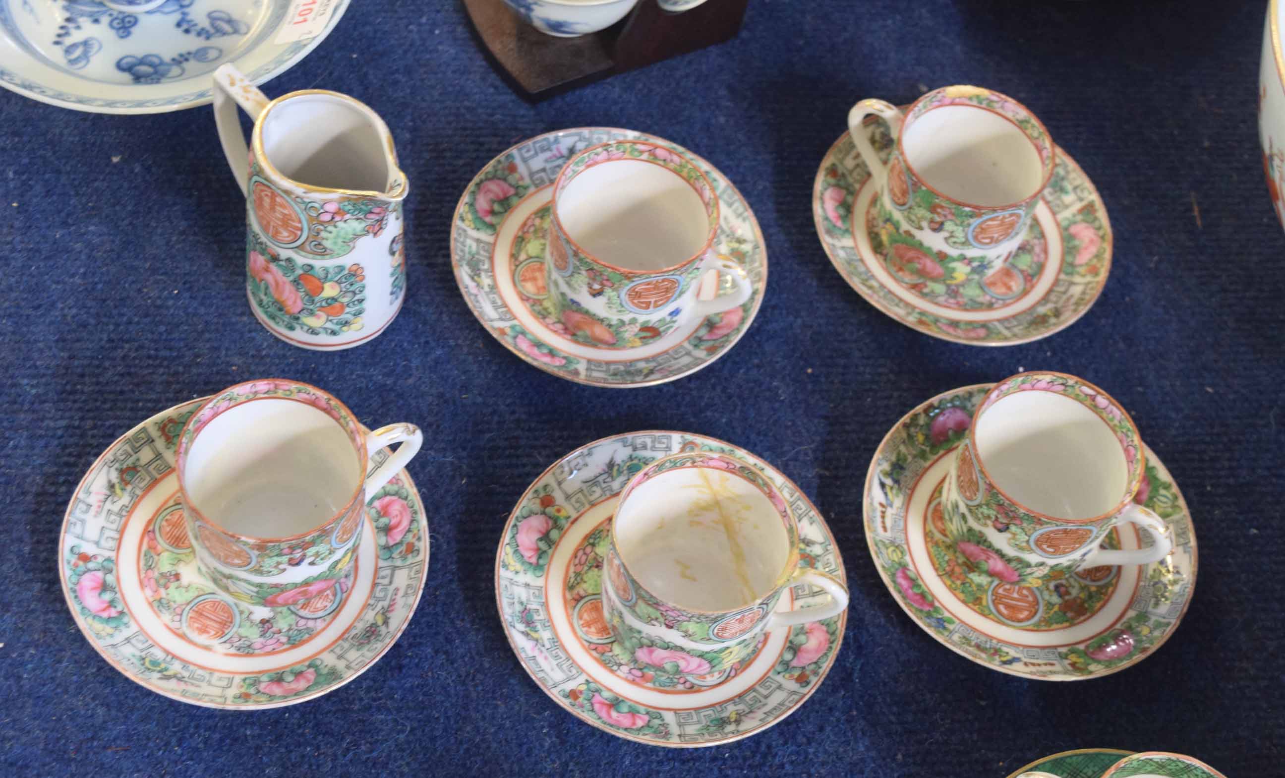 Part Chinese porcelain tea set, comprising five cups and saucers decorated in famille rose designs