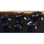 Group of six ebony wooden elephants with bone/ivory tusks