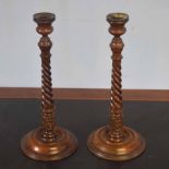 Pair of mahogany table candlesticks with urn formed sconces, spiral twist stems terminating in