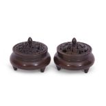 Two small Chinese bronze censers with pierced covers and six character reign mark to base, raised on