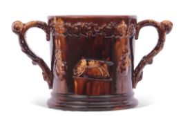 Large Staffordshire treacle glazed frog loving cup, the treacle body decorated in relief with