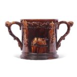 Large Staffordshire treacle glazed frog loving cup, the treacle body decorated in relief with