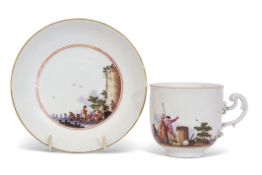 Meissen cup and saucer circa 1745, painted with Kauffahrtei within a landscape with a castle and