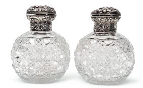 Pair of late Victorian hobnail cut oval glass scent bottles, the hinged lids and collars heavily