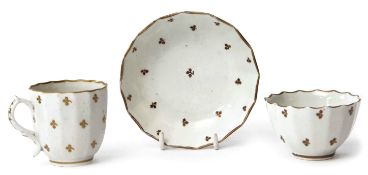 Lowestoft porcelain trio, circa 1790, with gilt sprigged design