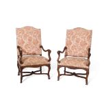 Pair of European walnut high back armchairs, slightly splayed arms terminating in scroll moulded