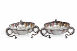 Pair of Edward VII silver bon-bon dishes of round lobed form, supported by three scroll handles