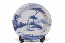 18th century English Delft bowl, probably Lambeth, the centre painted with a lady in a landscape,