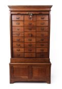 Early 20th century oak office cabinet with tambour shutter front enclosing a fitted interior of 24