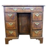 Queen Anne period walnut, kneehole desk of small proportions, the quatered and crossbanded top with