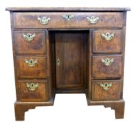 Queen Anne period walnut, kneehole desk of small proportions, the quatered and crossbanded top with