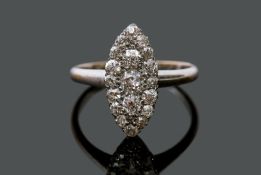 A precious metal diamond marquis shape cluster ring, set with graduating old cut diamonds, the