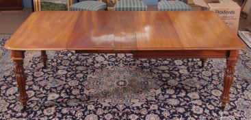 William IV mahogany extending dining table of rectangular design with rounded corners, raised on