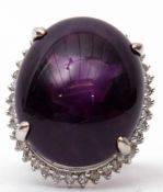 Large amethyst and diamond dress ring, the large oval shaped cabochon 24mm x 24mm, four claw set and