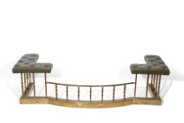 Brass and leather upholstered large club fender with twisted uprights and central bowed gallery,