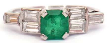 Emerald and diamond ring, the square emerald raised between stepped baguette set diamond