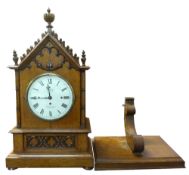 Large oak cathedral style bracket clock with matching bracket, arched top with central decorative