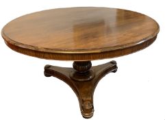Early 19th century rosewood circular pedestal dining table with moulded edge over a moulded baluster