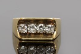 18ct gold and four-stone diamond ring of angular design, the central groove shaped gallery featuring