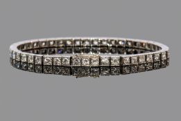 Early 20th century diamond and platinum line bracelet comprising 45 round cut diamonds, claw set