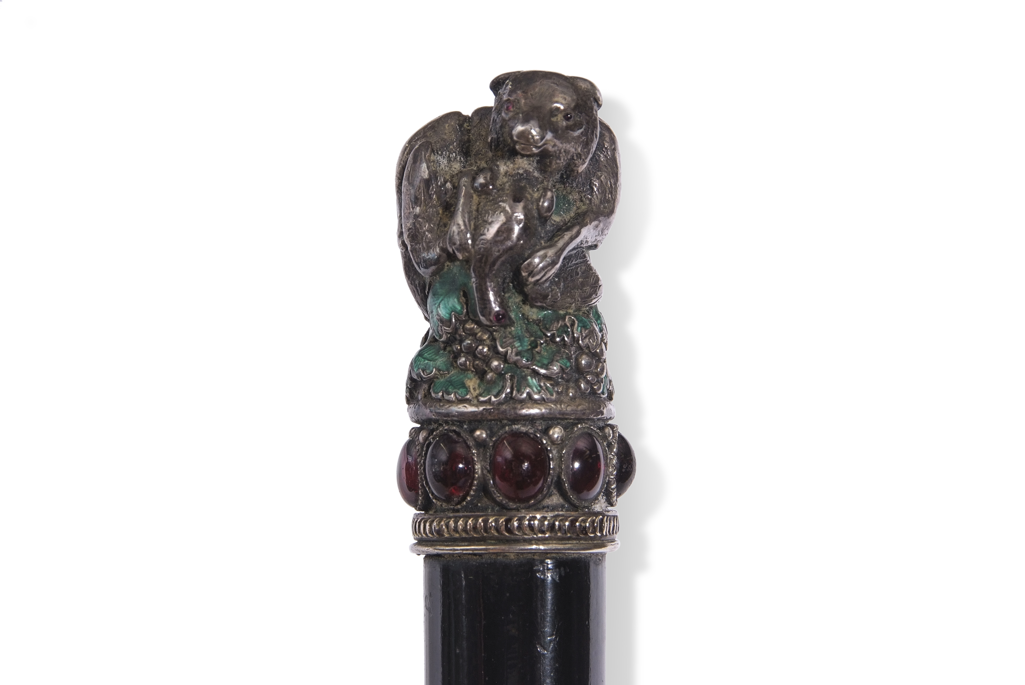 Ebonised cane, the white metal handle decorated in the form of a bear with prey with traces of green