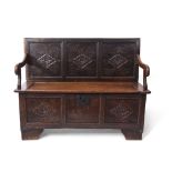Oak monk's bench, three panelled back and front incised with geometric diamond shaped designs,