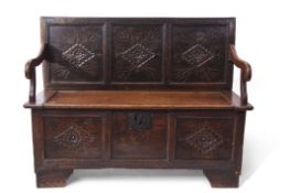 Oak monk's bench, three panelled back and front incised with geometric diamond shaped designs,